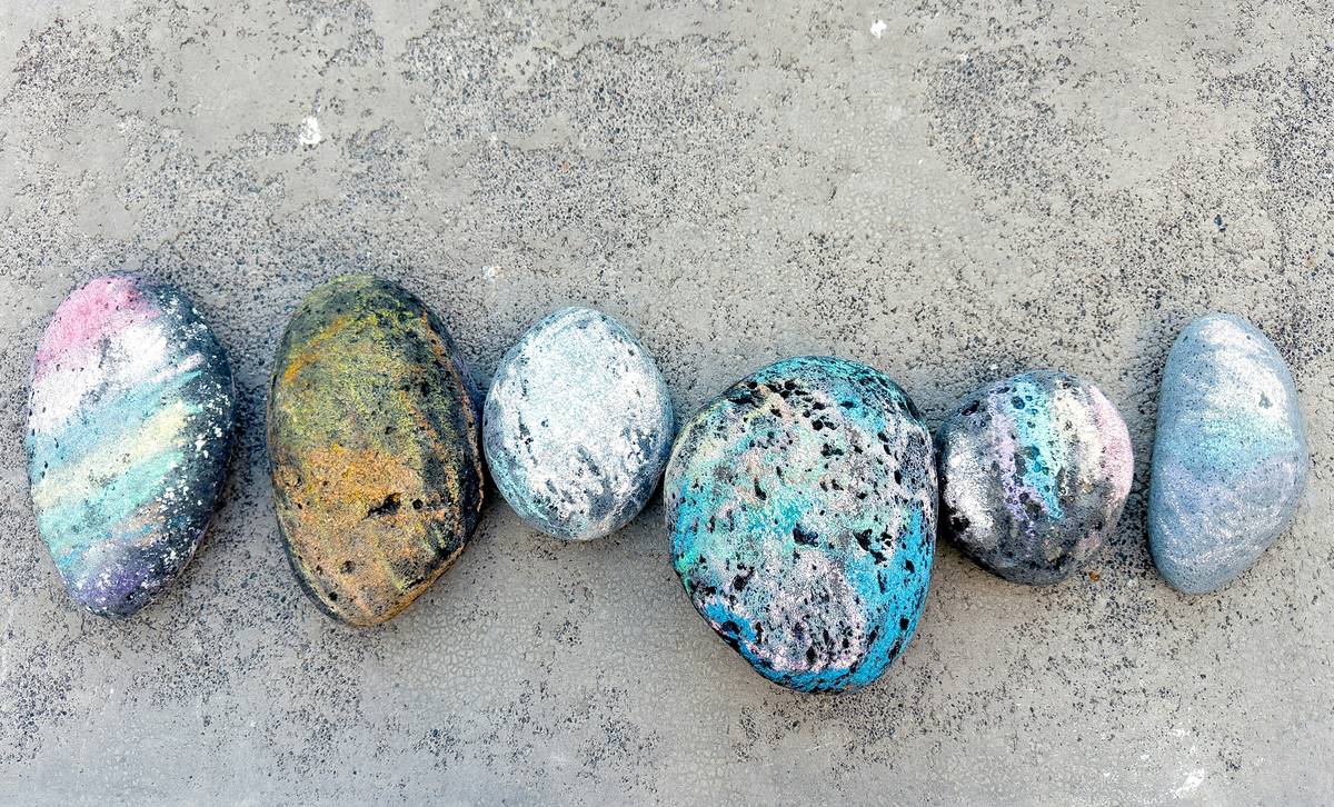 painted rock art ideas featuring colorful animal designs on smooth river stones